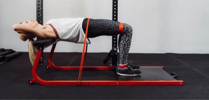 girl going banded hipthrust on bench